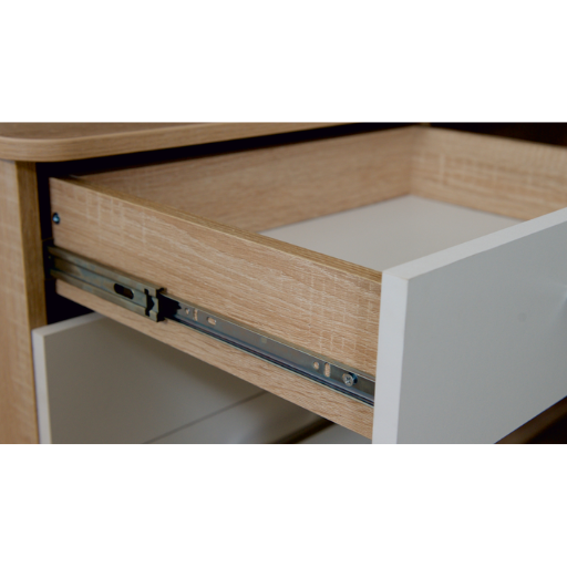 Kitchen pull-out drawer with chrome basket holding black bottles, white cabinetry, and gray floor