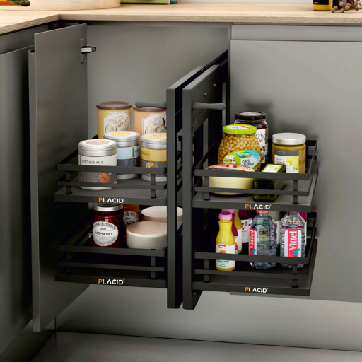 Kitchen pull-out drawer with chrome basket holding black bottles, white cabinetry, and gray floor