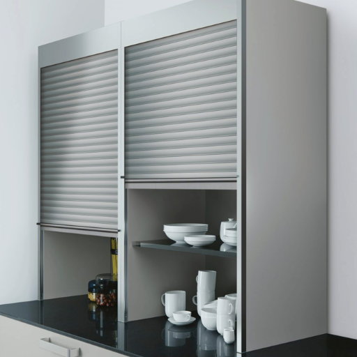 Kitchen pull-out drawer with chrome basket holding black bottles, white cabinetry, and gray floor